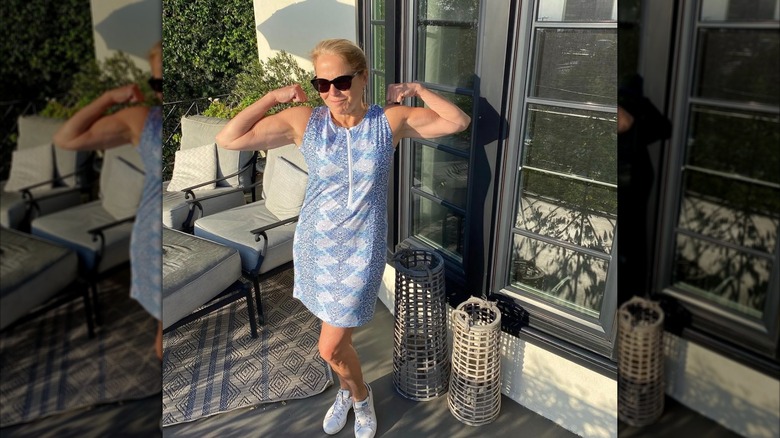 Katie Couric posing for a photo while showing off her strong biceps