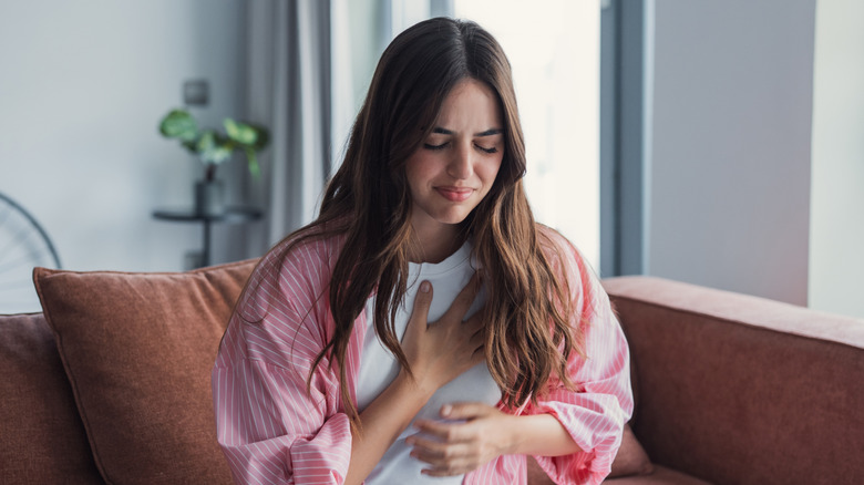 Millennial woman clutching her chest