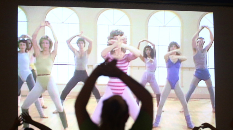people watching the original Jane Fonda workout video on a TV screen