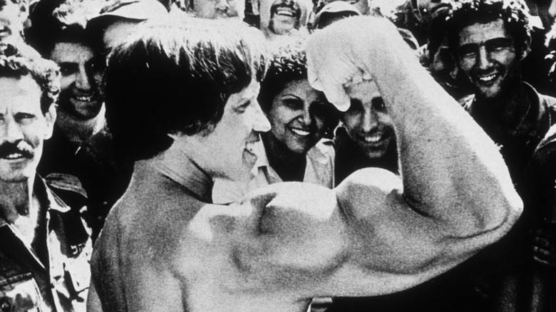 Smiling Arnold Schwarzenegger shows off his defined muscles