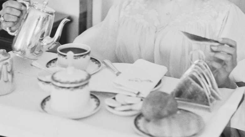 woman in 1960s eating breakfast in bed