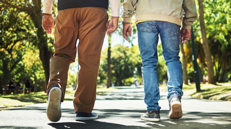 image of mature men walking outdoors from behind