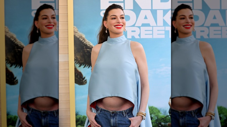 Anne Hathaway posing with her baby bump visible