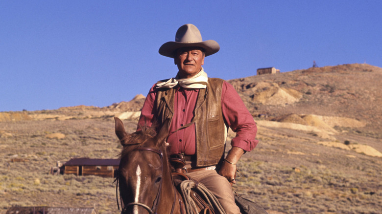 John Wayne riding a horse