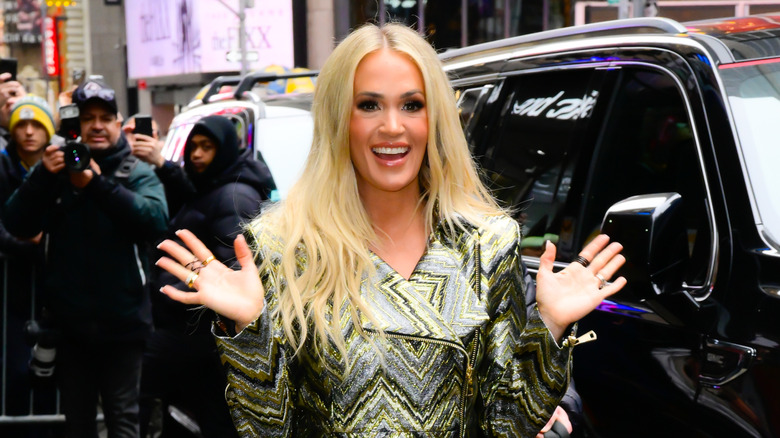 Carrie Underwood waves in New York City outside
