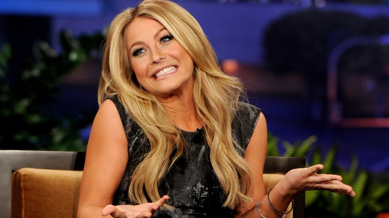Julianne Hough sitting while being interviewed on a talk show