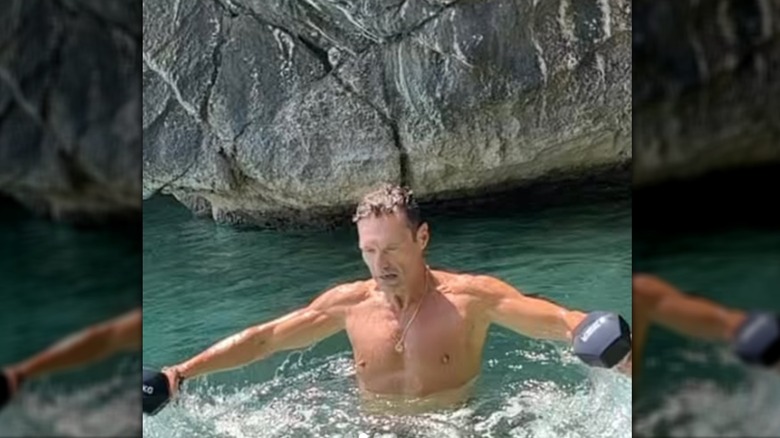 Ryan Seacrest doing underwater sea training with weights