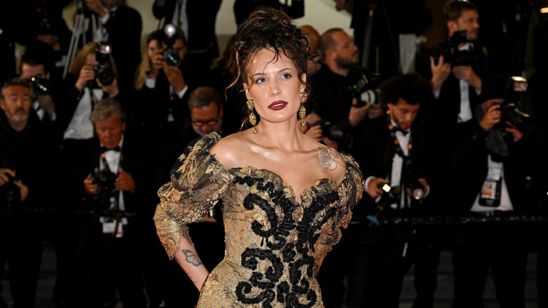 Halsey posing in a golden dress