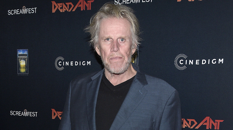 Gary Busey posing in a suit